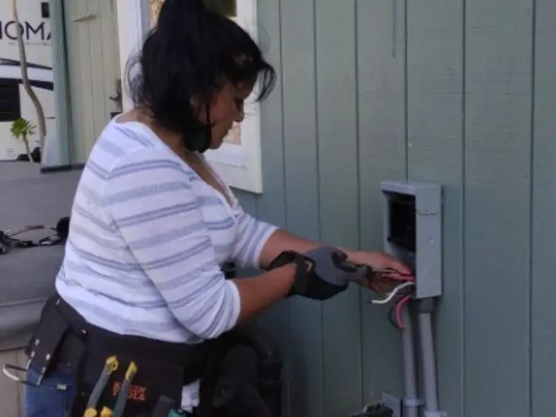 Licensed electrician wiring an exterior subpanel in New Palestine
